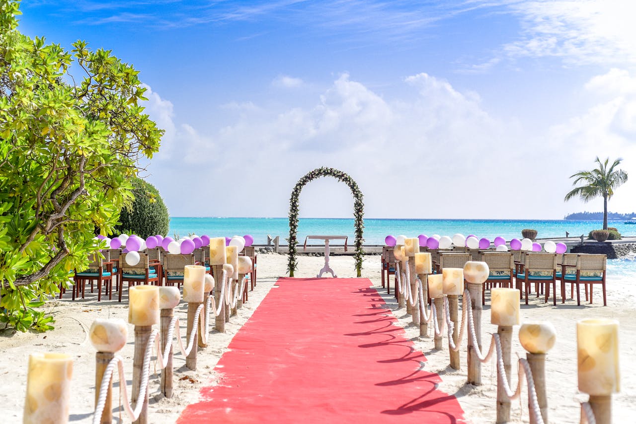 The Art of Drawing Readers In: Your attractive post title goes here A scenic tropical beach wedding setup with a red carpet aisle and ocean views, perfect for destination weddings.